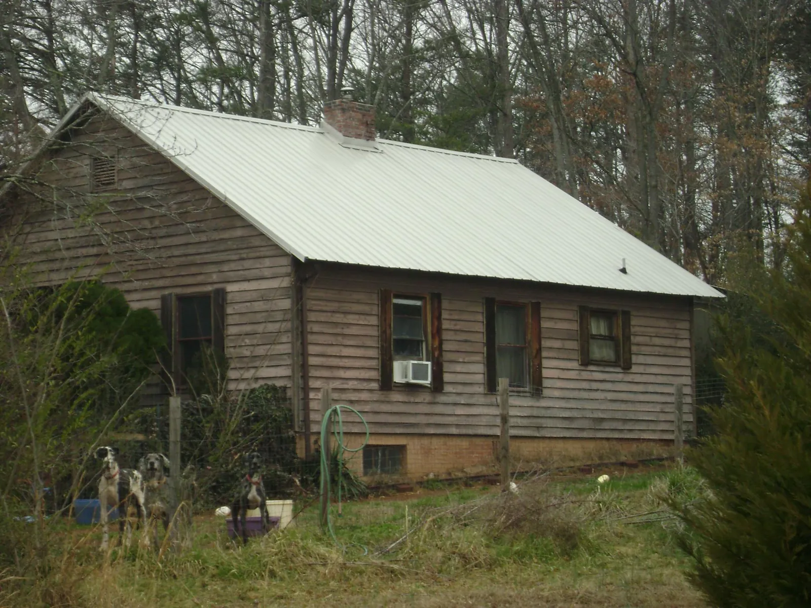 White metal roof on an old wood sided farmhouse, from a Metal Roof Installation job in Somerset